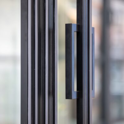 close up of slimline patio doors black modern handle.